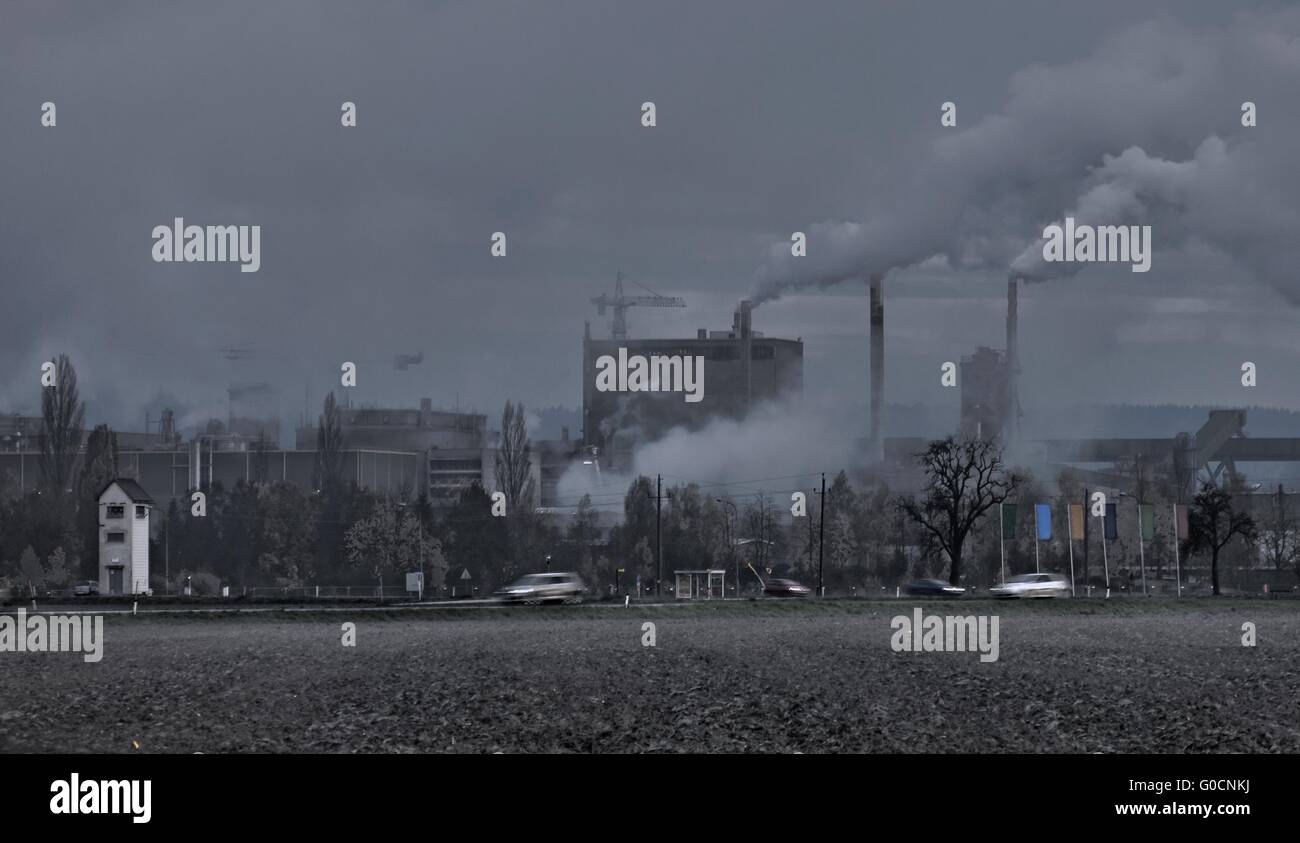 periphery with smoking chimneys in the twilight Stock Photo