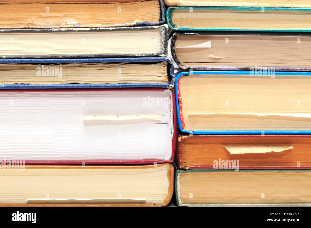 A stack of old books with bookmarks in different d Stock Photo