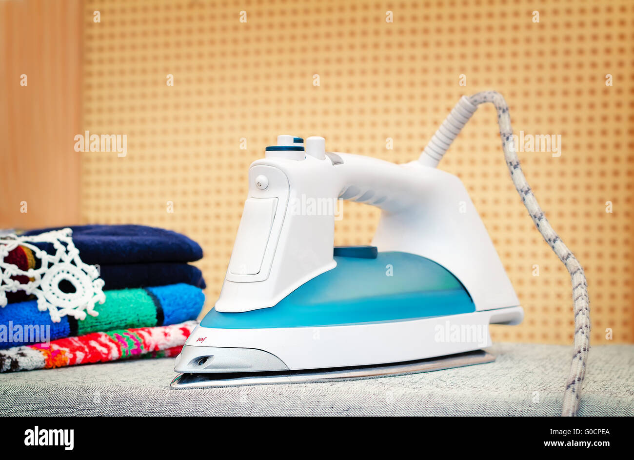 Electric iron on the Ironing Board. Stock Photo
