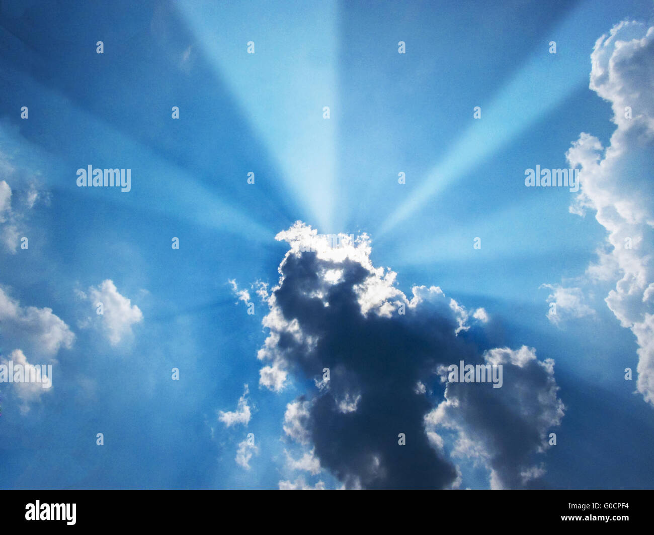 Sun beam coming out of the clouds in midday Stock Photo