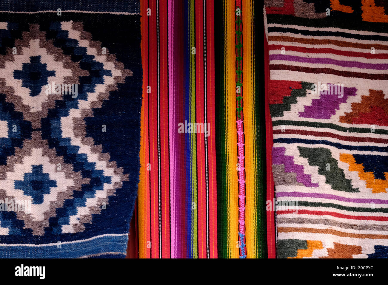 Multi coloured traditional fabrics for sale at the old part of the city of  Flores located on an island on Lake Peten Itza in the region of Peten Basin  in northern Guatemala