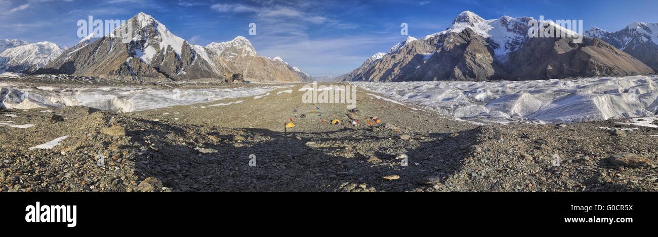 Scenic panorama of tents on Engilchek glacier in picturesque Tian Shan mountain range in Kyrgyzstan Stock Photo