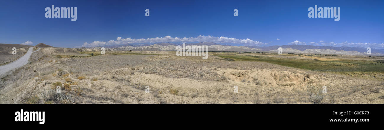 Scenic panorama of green grasslands in Kyrgyzstan Stock Photo