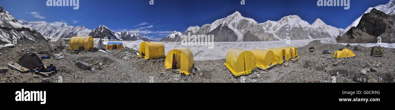 Scenic panorama of tents on Engilchek glacier in picturesque Tian Shan mountain range in Kyrgyzstan Stock Photo