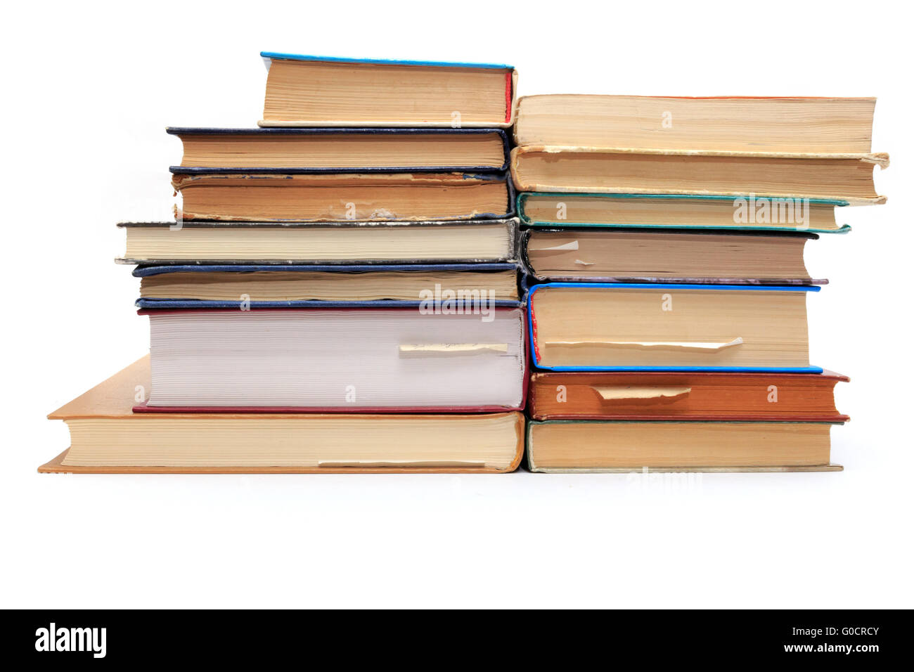 A stack of old books with bookmarks in different directions on different pages. Stock Photo