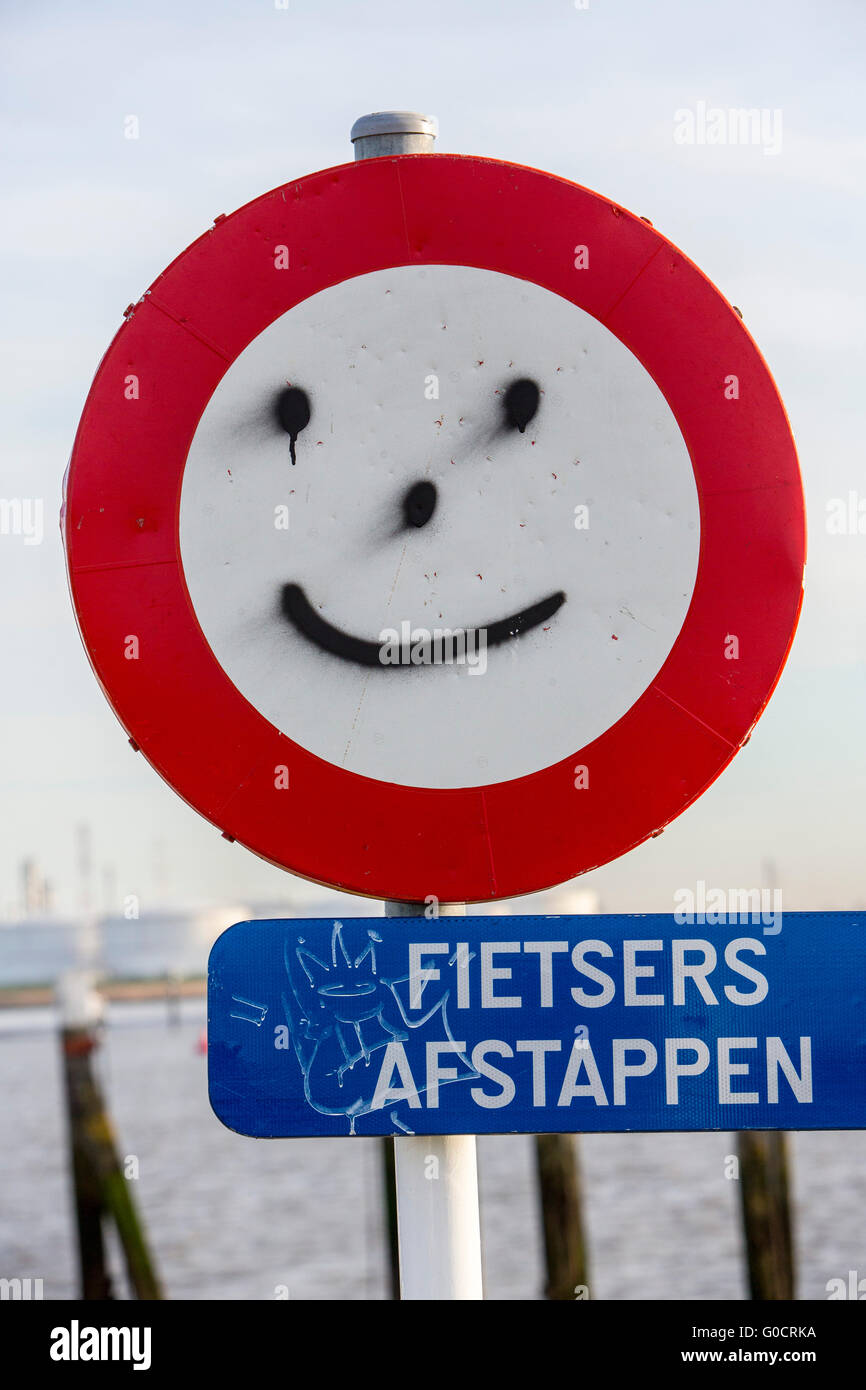 Traffic sign with a smiley face graffiti, Stock Photo