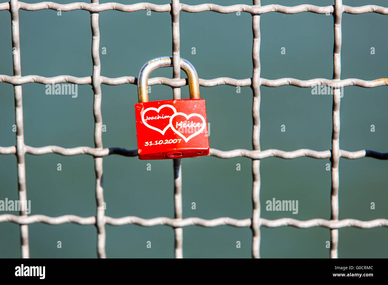 Love lock on a bridge grating, a custom of loving couples, the key will thrown into the river, Stock Photo