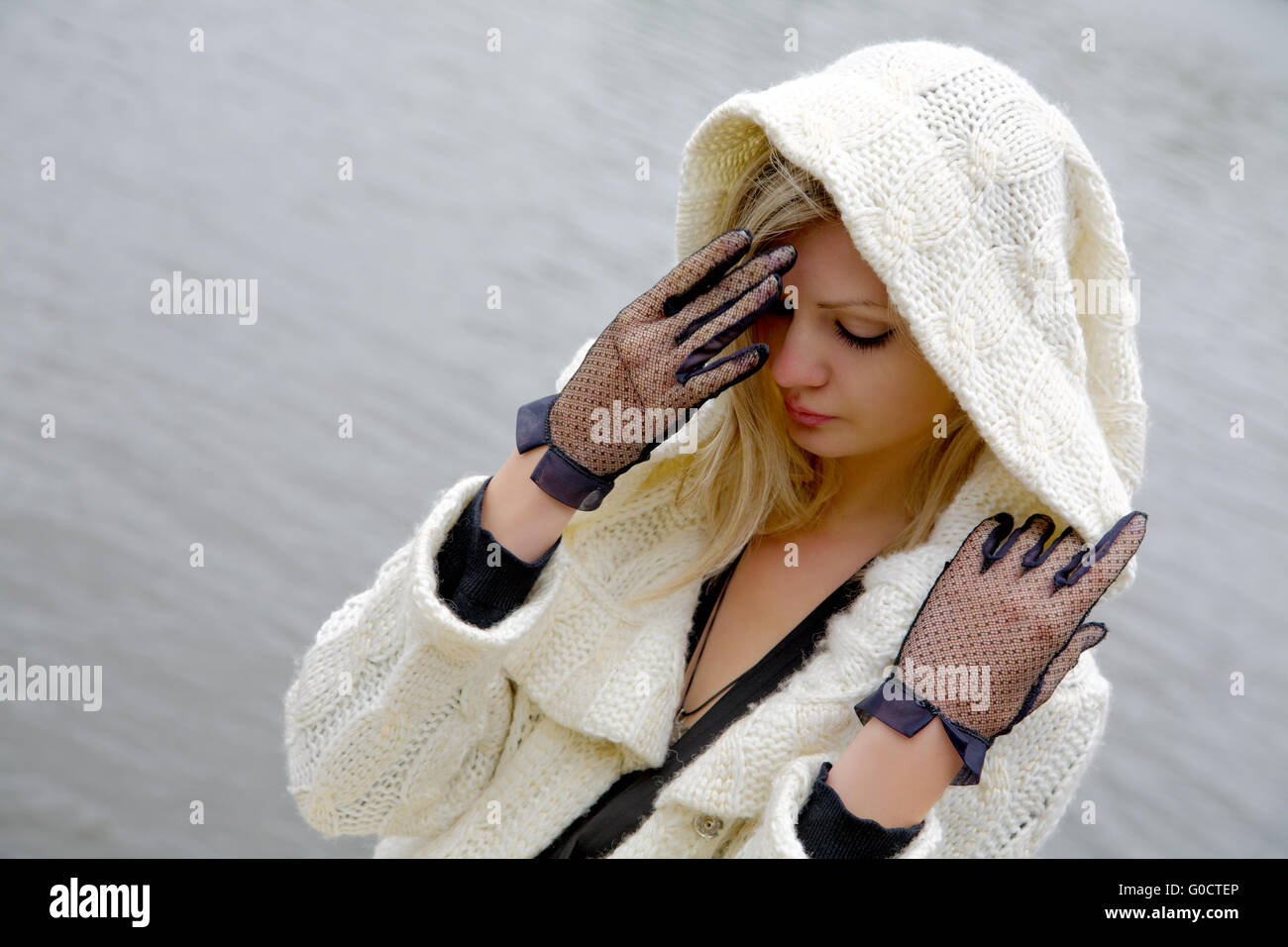 The girl in despair and grief against the river Stock Photo
