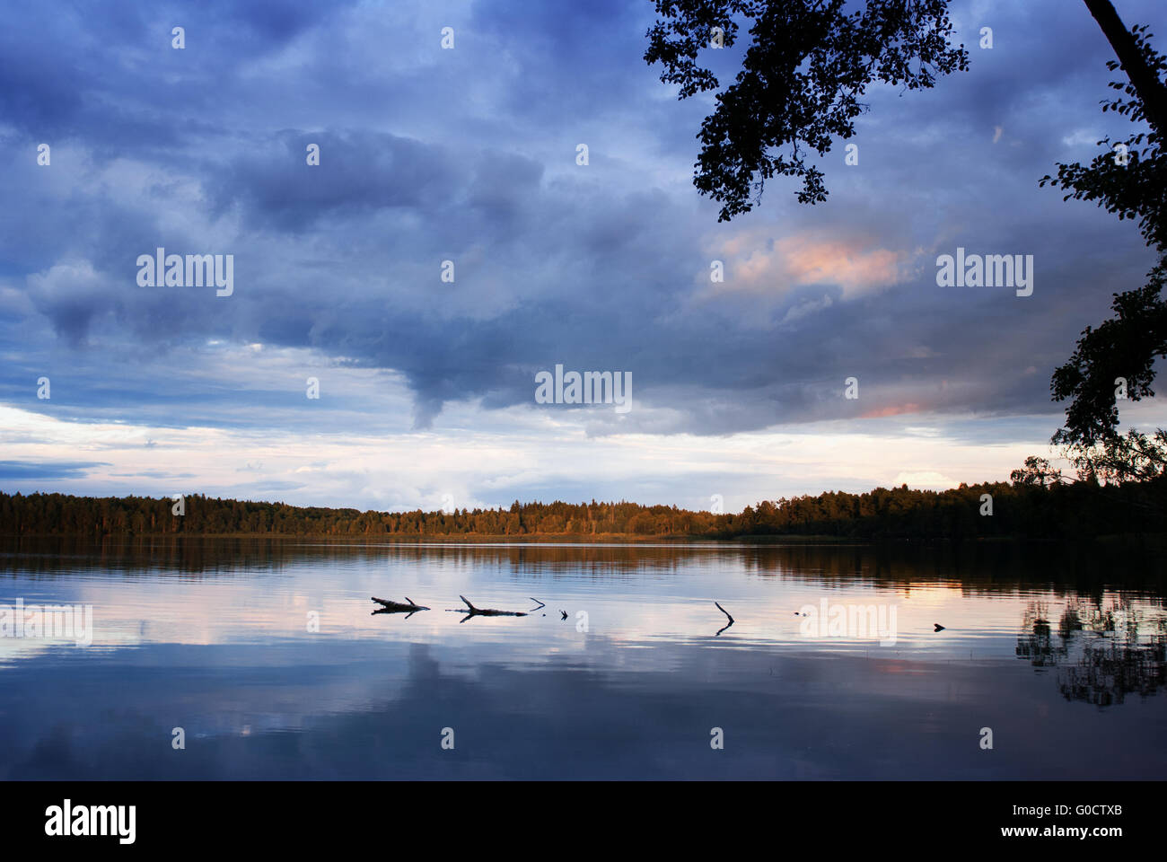Sunset over the forest lake with dramatic sky Stock Photo - Alamy