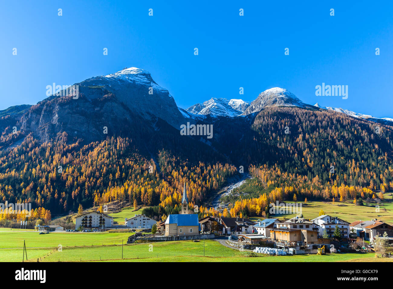 Beautiful view of the small town Bergun and the alps including Piz Ela from the sightseeing train Bernina Express in golden autu Stock Photo