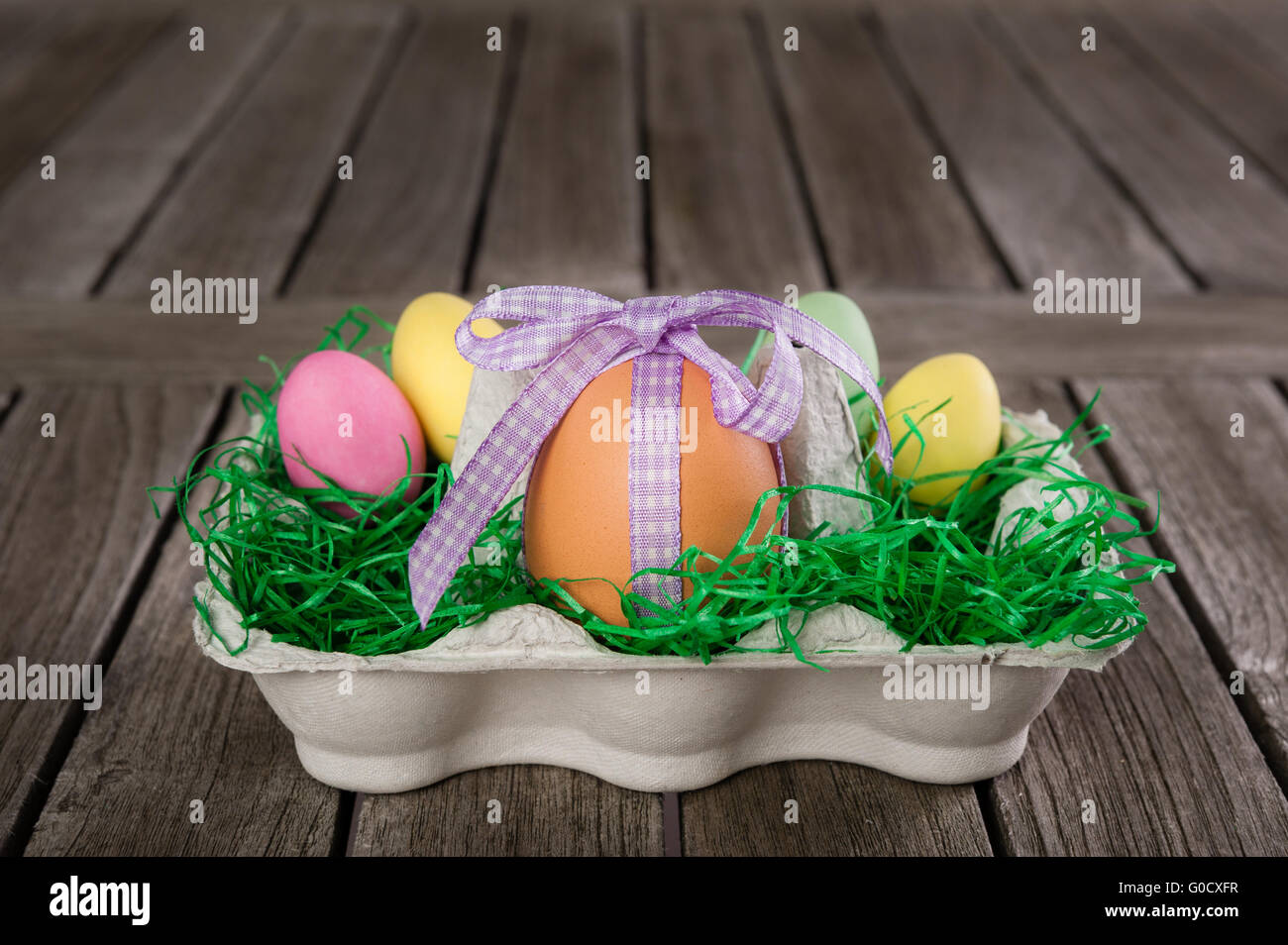 Easter Nest with eggs on a wooden table. Stock Photo