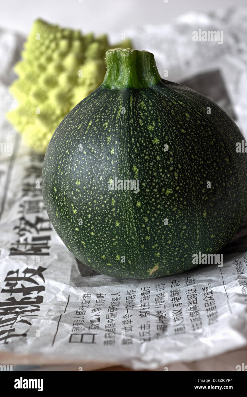 Courgette on Chinese Newspaper (Wrapping Material) Stock Photo