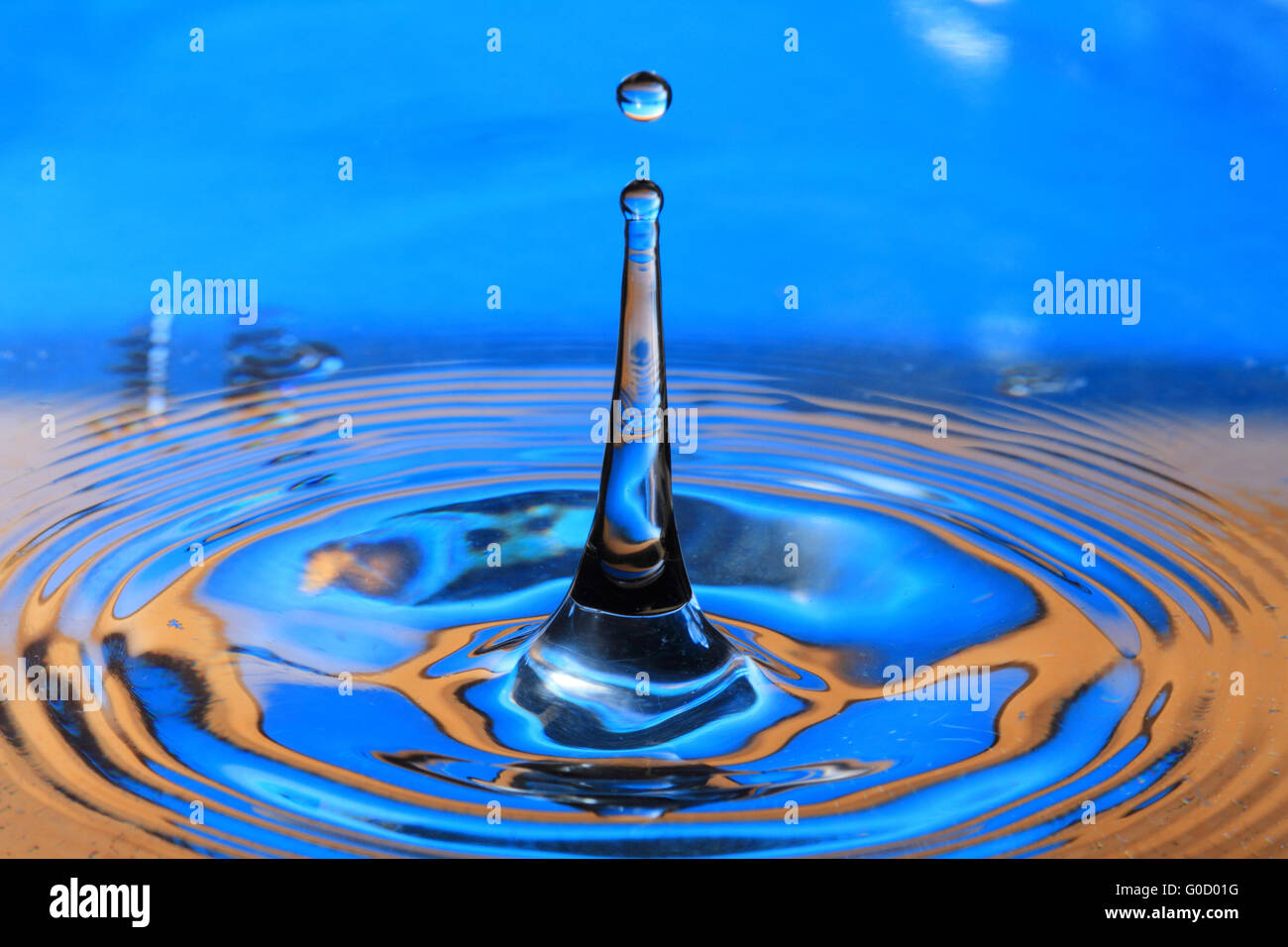 Blue orange water drop splashing with waves Stock Photo Alamy