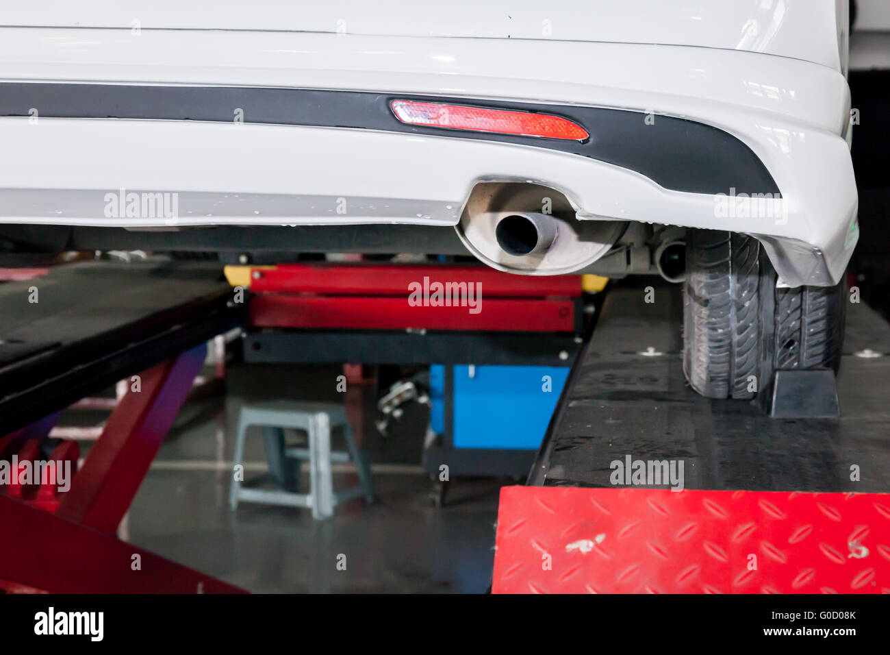 Car muffler in process of being modified in garage Stock Photo Alamy