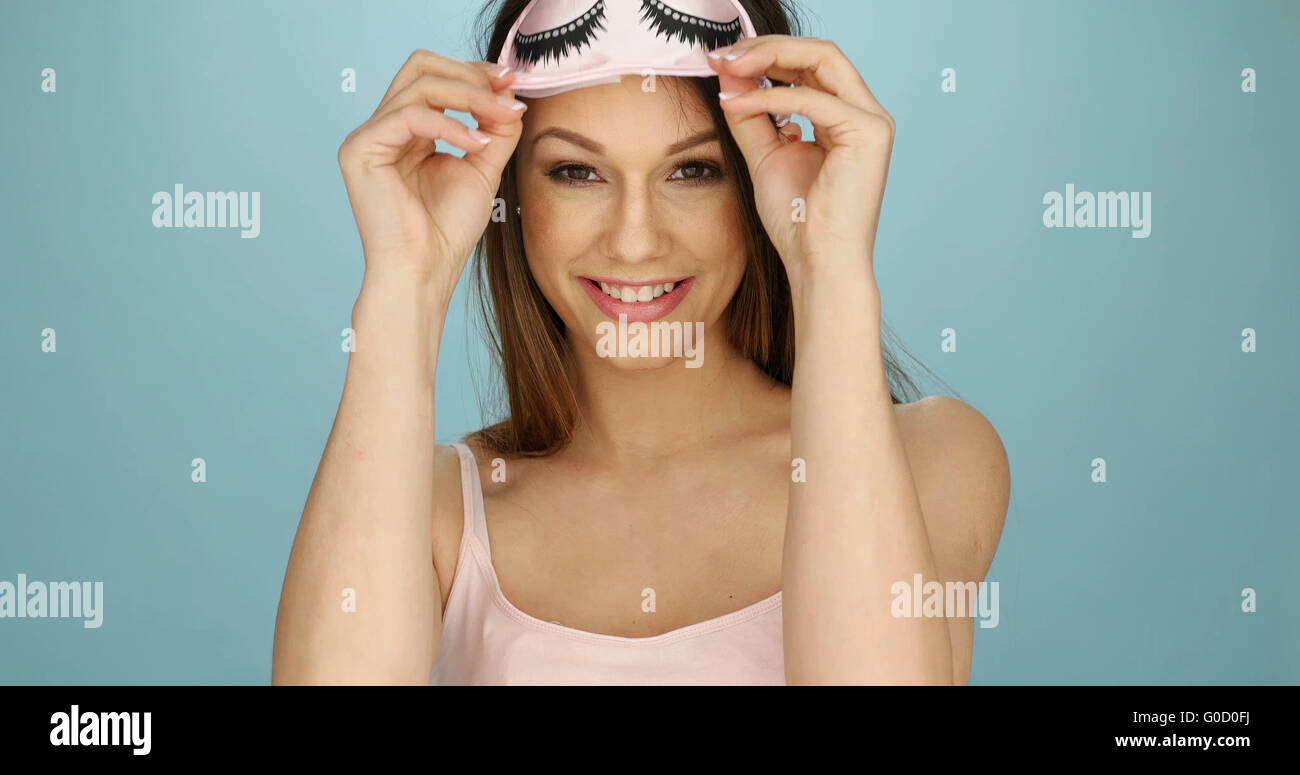 Pretty young woman with a sleep mask Stock Photo