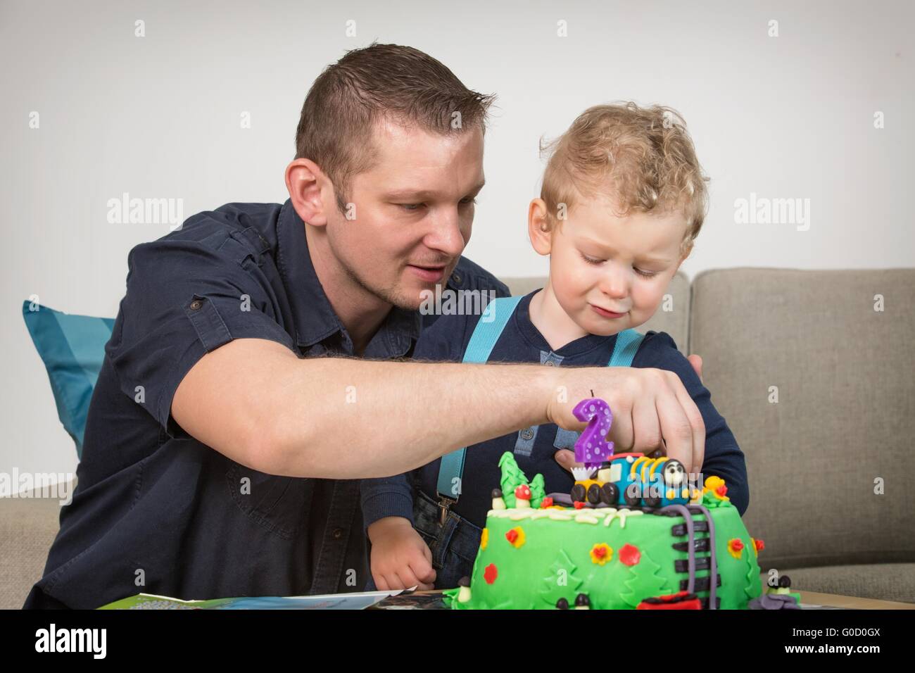 Little boy celebrating his father's second birthday Stock Photo
