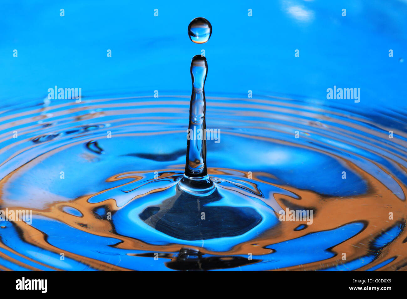 Blue orange water drop splashing with waves Stock Photo Alamy