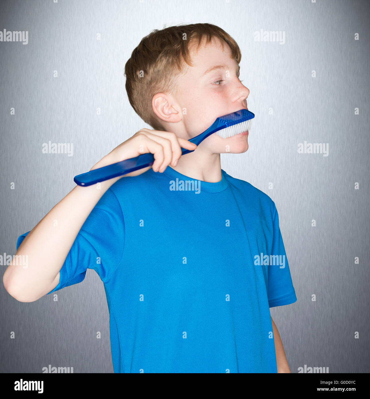Little boy brushing teeth with plastic toothbrush Stock Photo