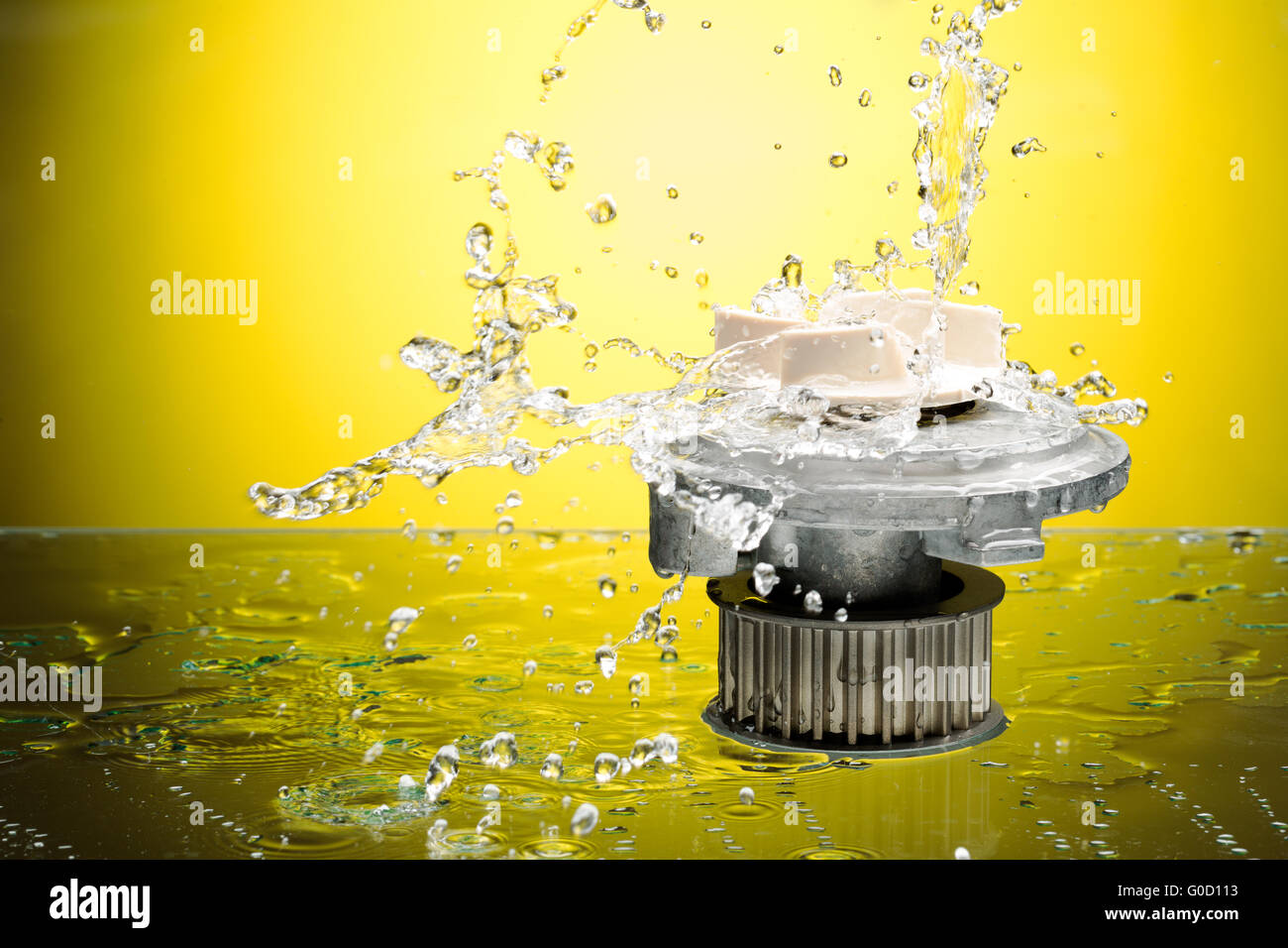 Auto parts, engine cooling pump in water splash on yellow gradient