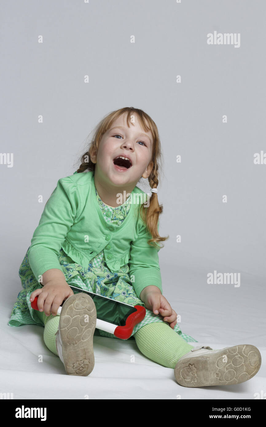 Girl playing with tablet Stock Photo