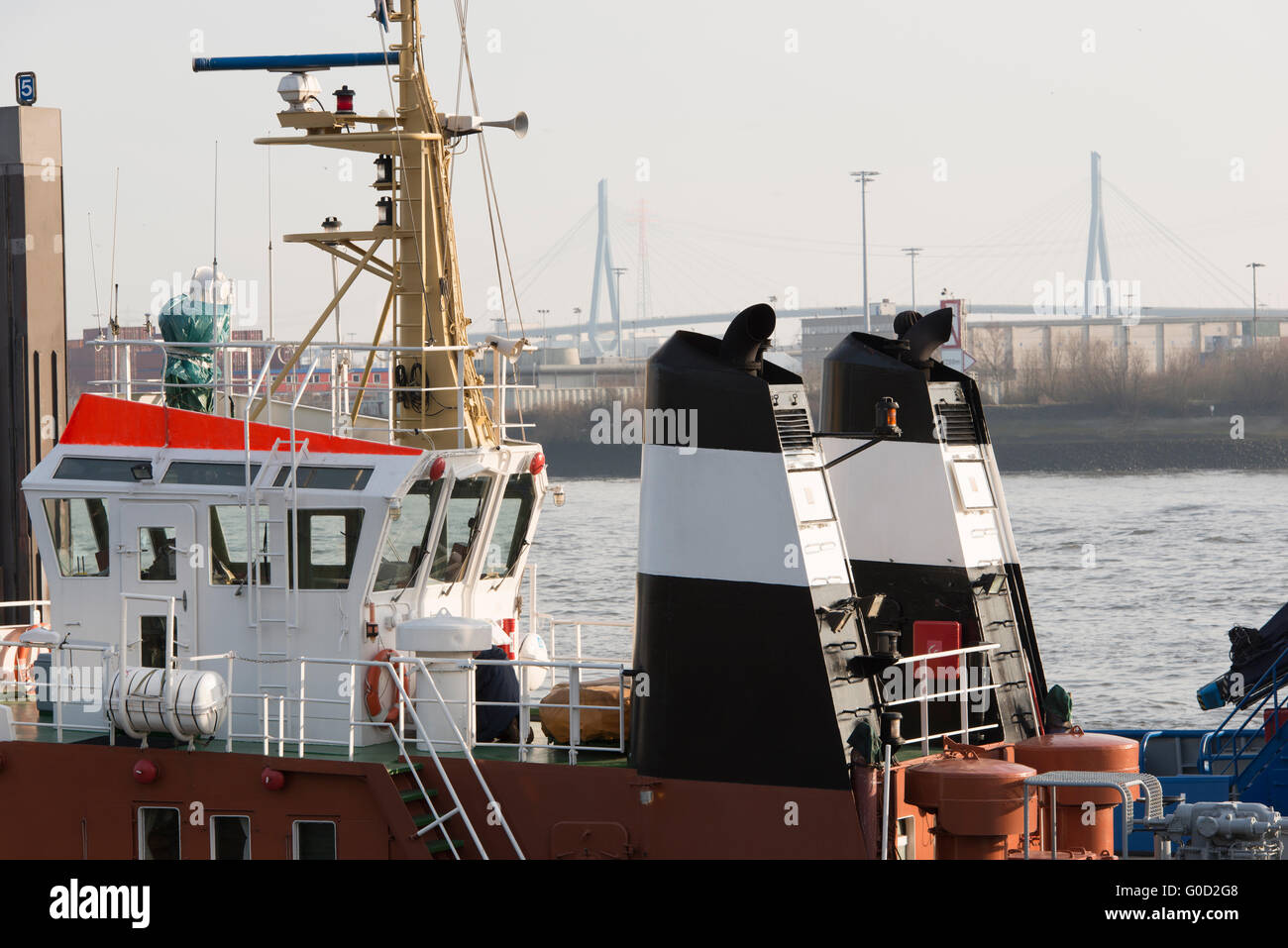 Tug Boat in the port of Hamburg at the pier Stock Photo