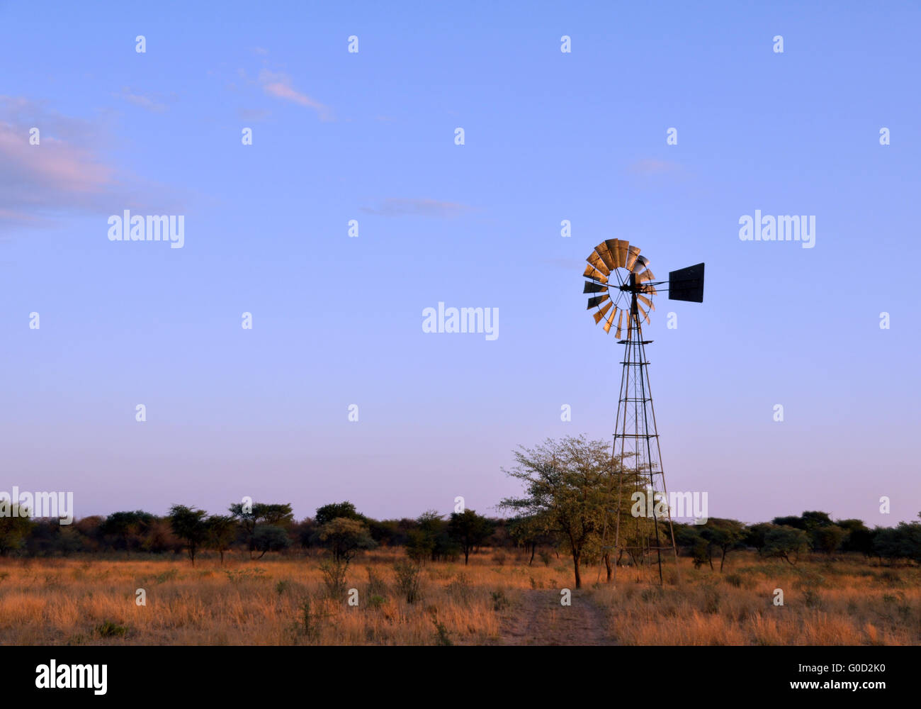 Windmill in desert Stock Photo
