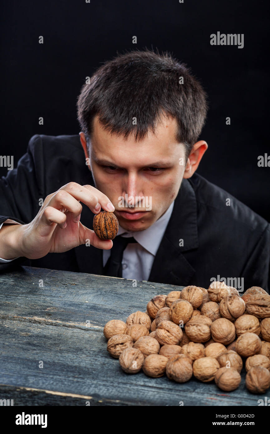 young man looking at a nut Stock Photo