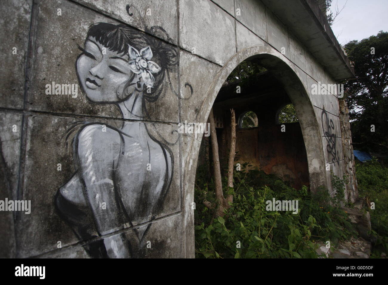 Ruined home in Kep, Cambodia, with graffiti. Stock Photo