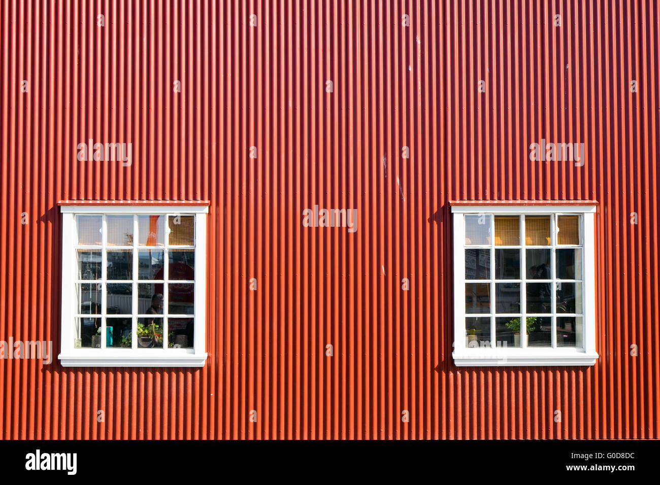 Red wall and two windows seen in Reykjavik, Iclean Stock Photo