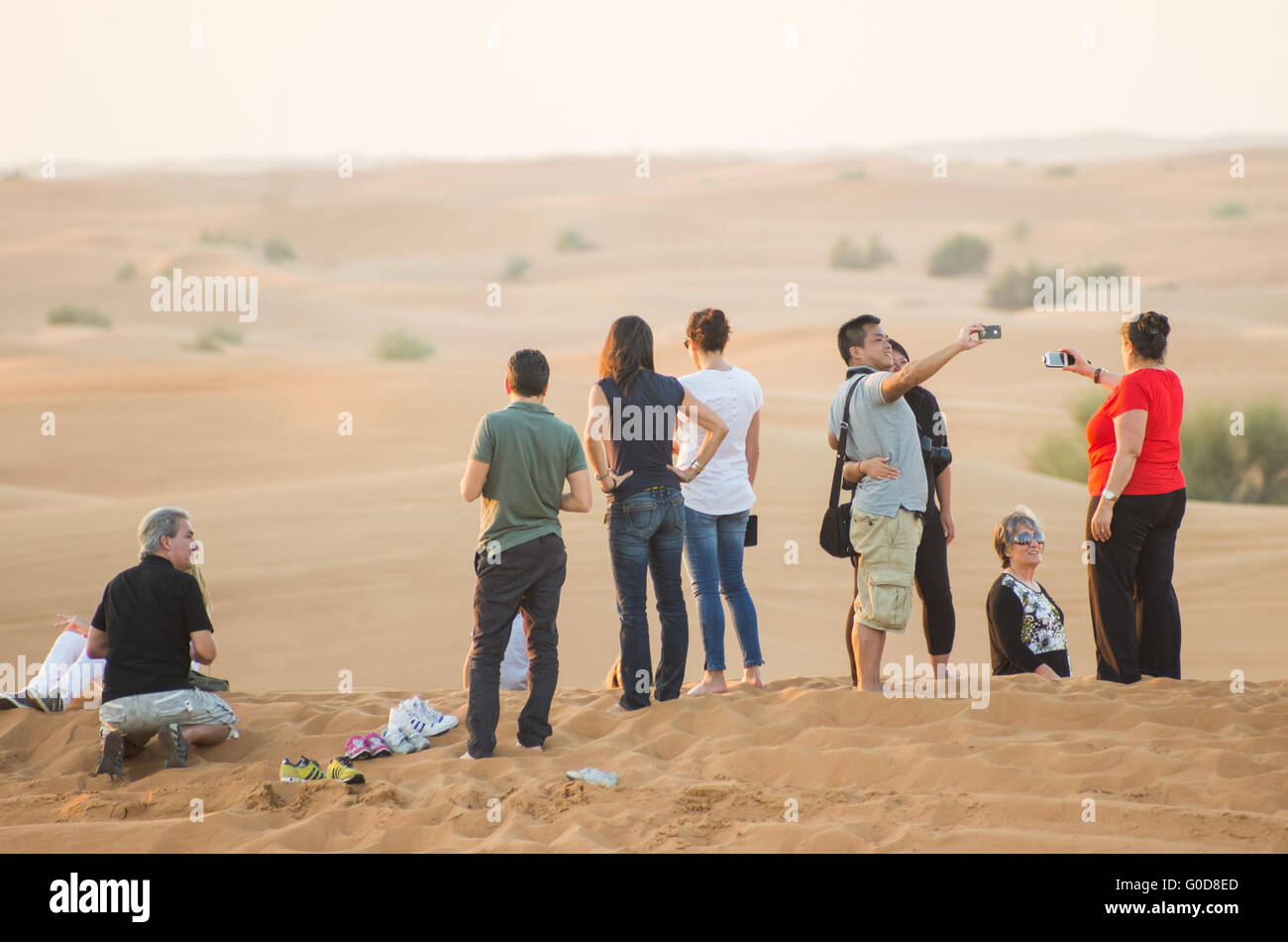 NOV 29 -DUBAI, UAE:    people watching the sunset and taking selfies in the Arabian Desert during a desert safari on the  29th o Stock Photo