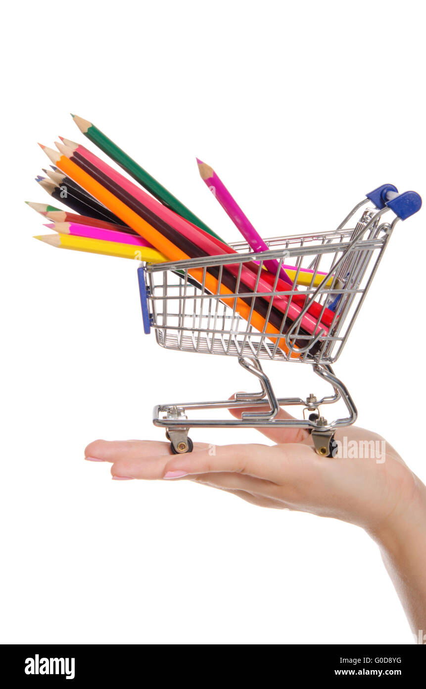 colored pencils in shopping trolley on the palm Stock Photo