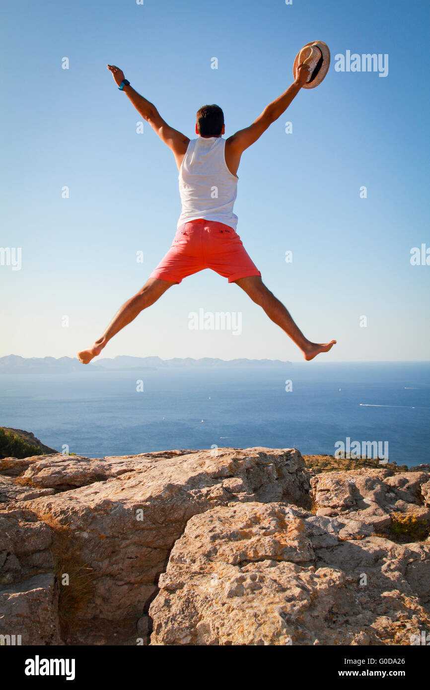Boy with open arms jumping for joy celebrating freedom Stock Photo Alamy