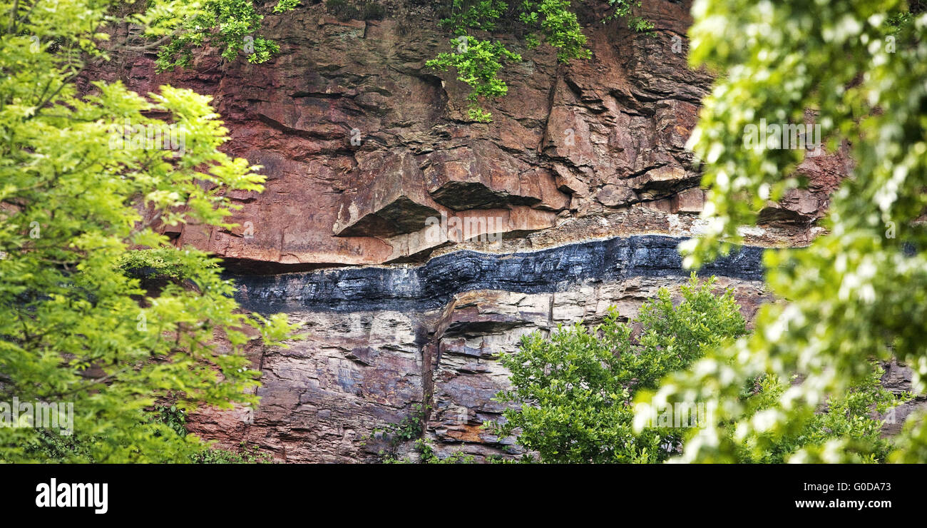 Geological outcrop with overground coal seam Stock Photo