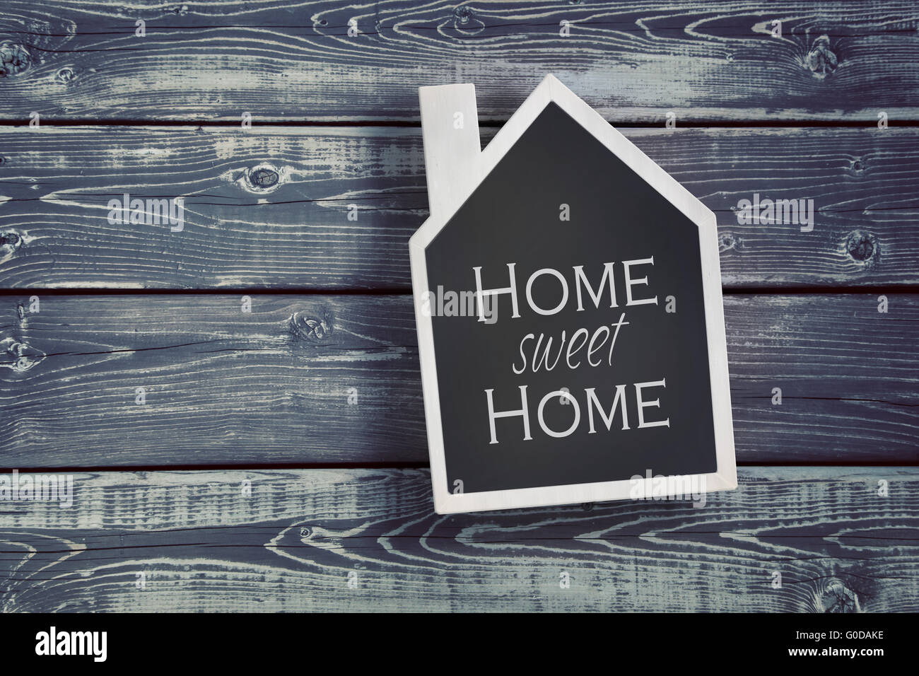 House shaped chalkboard on wooden plank background Stock Photo Alamy