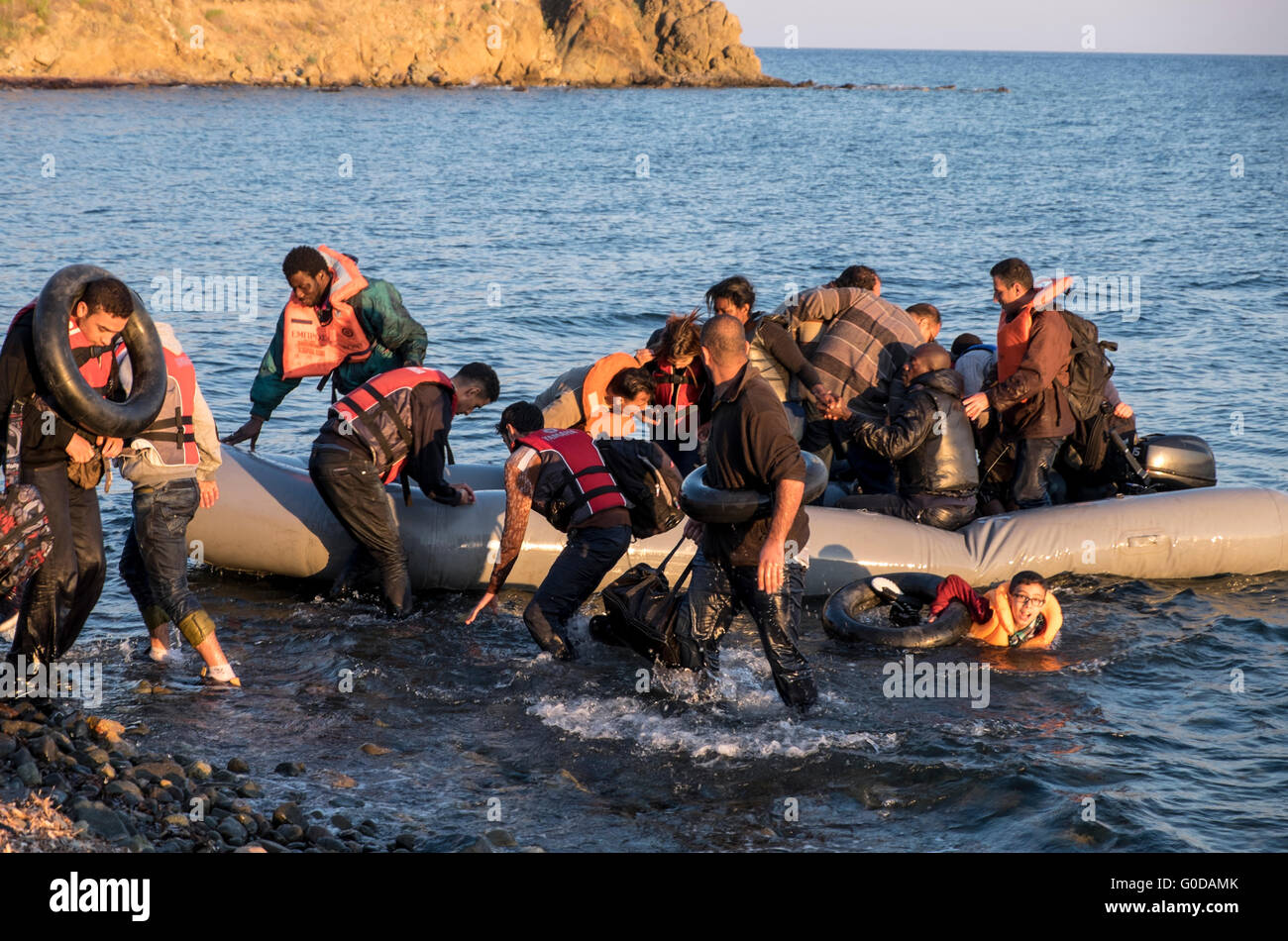 Refugees from Syrian, Afghanistan, Iraq and Somalia cross from Turkey to Greece in rafts arriving on the Greek island of Lesvos Stock Photo