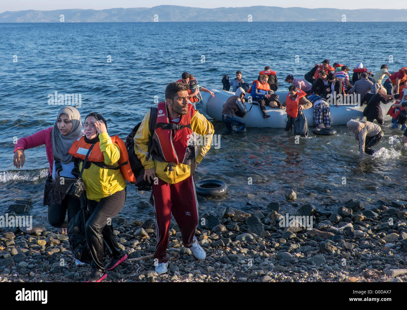 Refugees from Syrian, Afghanistan, Iraq and Somalia cross from Turkey to Greece in rafts arriving on the Greek island of Lesvos Stock Photo