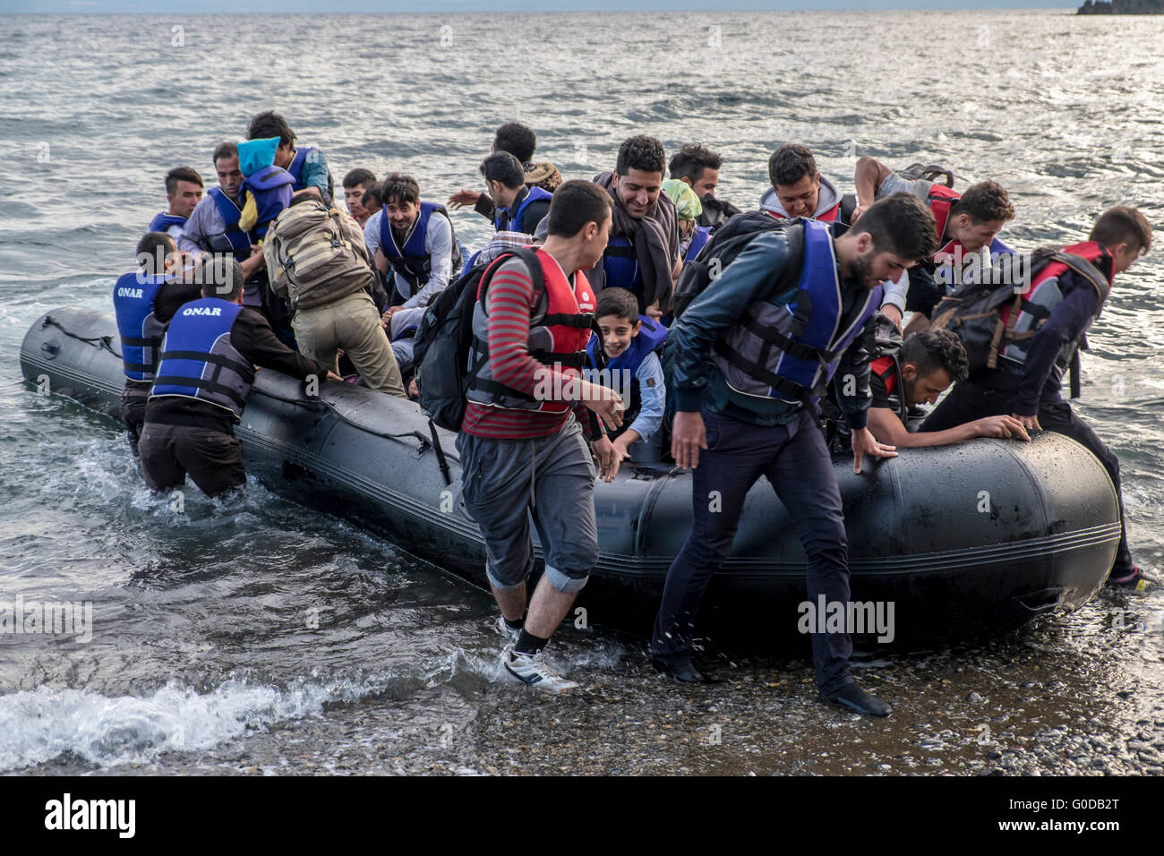Refugees crossing from Turkey to Greece in inflatable raft arrive on