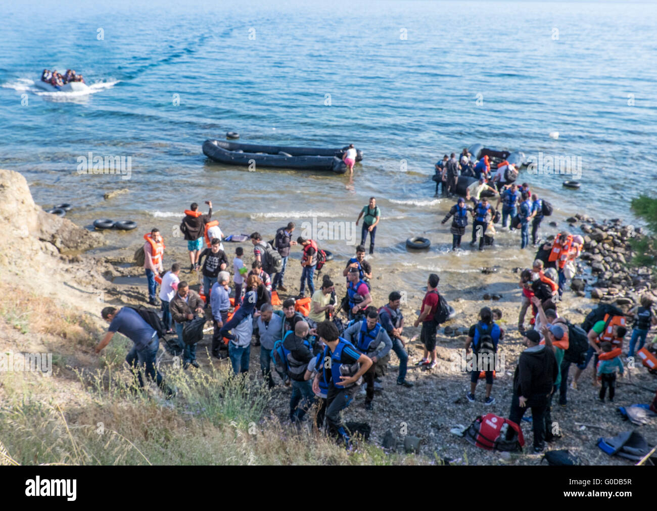 Four rafts of refugees crossing from Turkey to Greece arrive on the northern shore of the Greek island of Lesvos Stock Photo