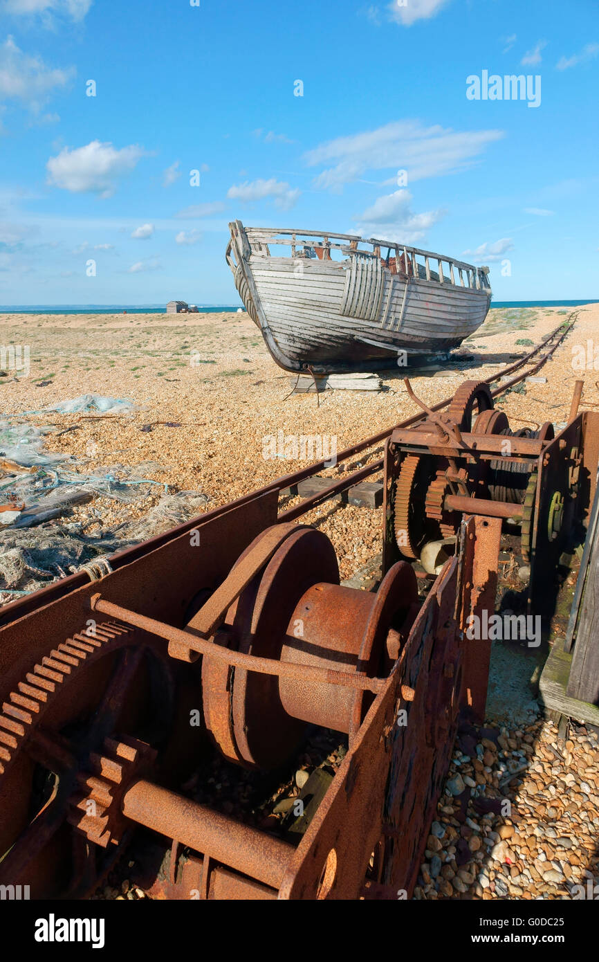 Abandoned old fishing boat on Dungeness shingle beach Kent England UK. The desolate landscape a favourite with photographers Stock Photo