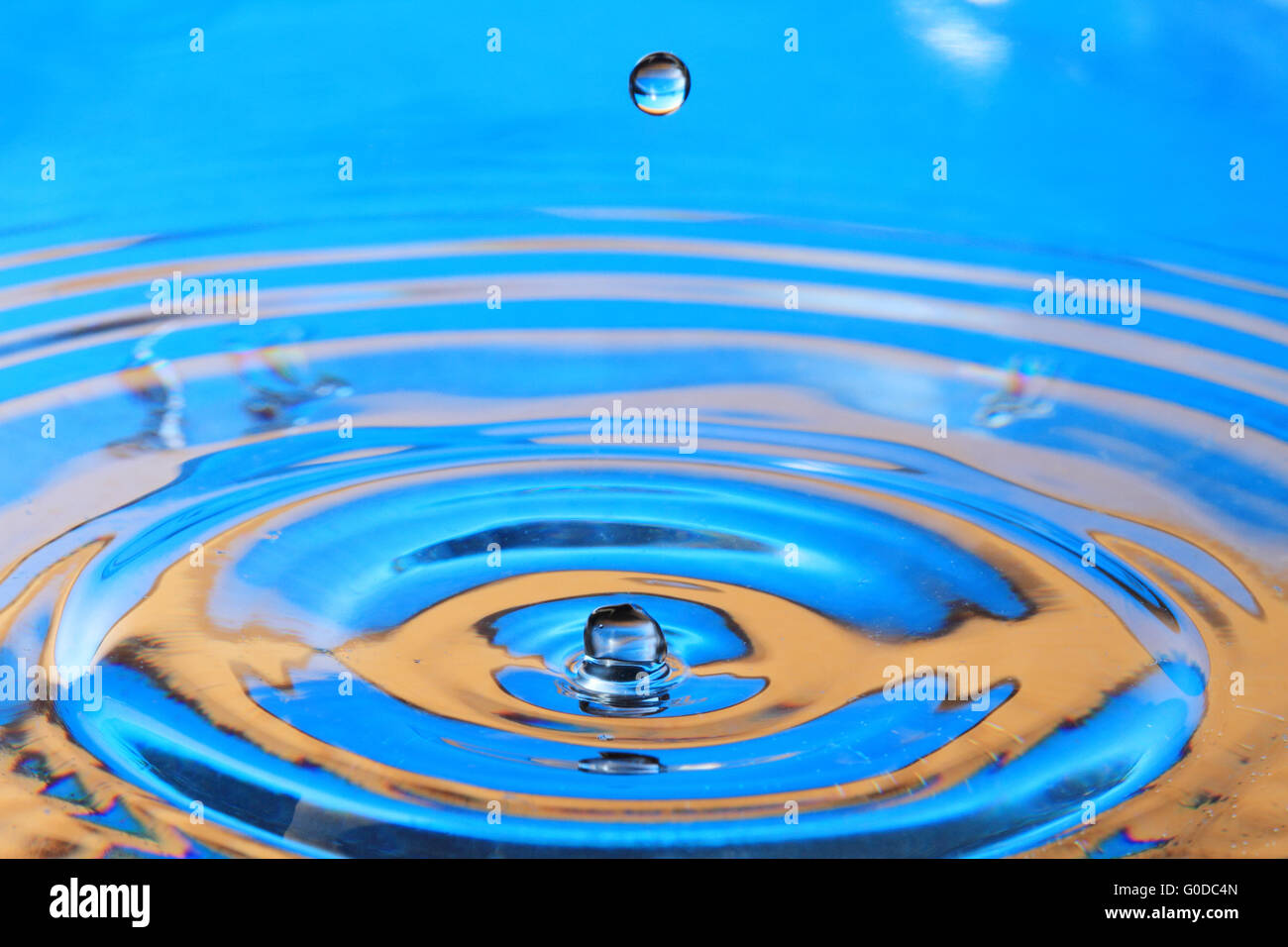 Blue orange water drop splashing with waves Stock Photo Alamy