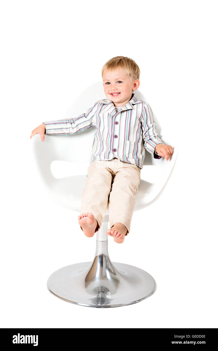 Boy shot in the studio on a white background in chair Stock Photo