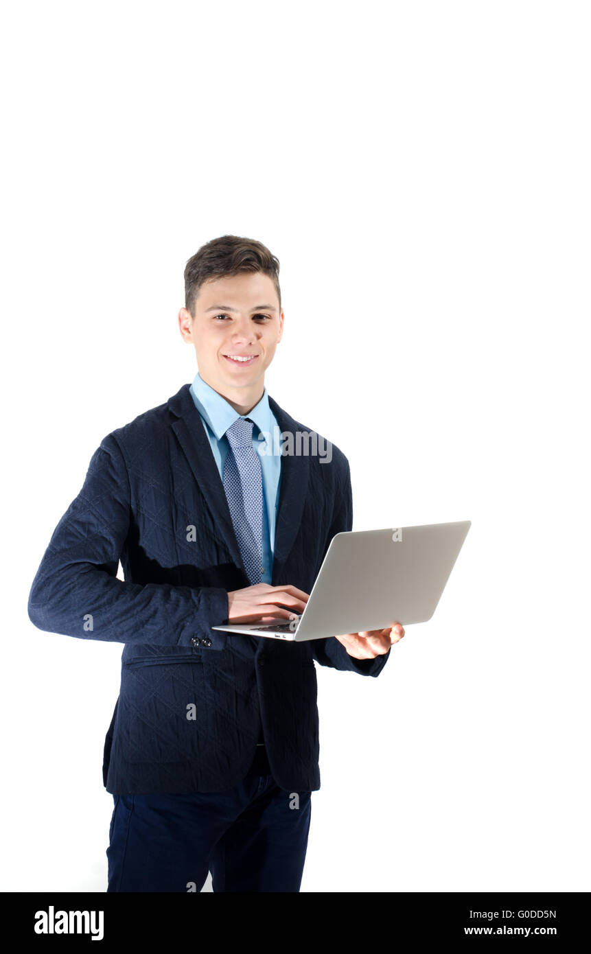 Happy student teenager working on laptop isolated in white background Stock Photo