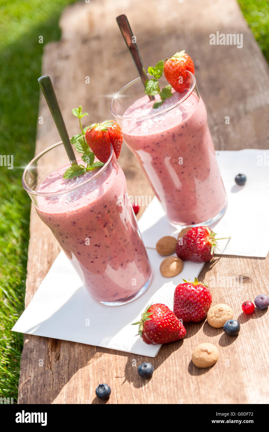 2 glasses with a berry milkshake and decoration on Stock Photo