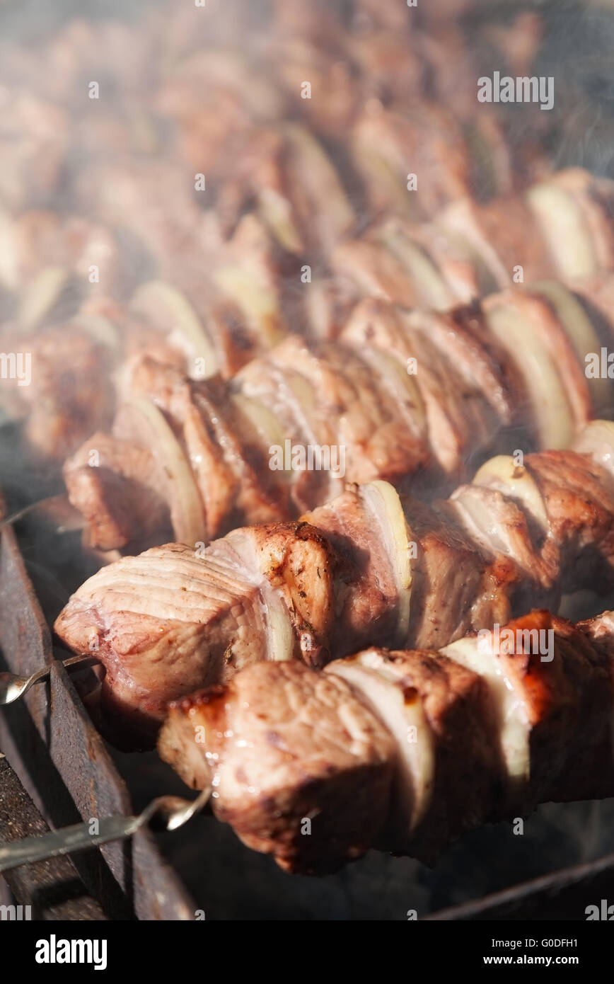 shashlik with onions. Juicy slices of meat being prepared in the heat. Delicious juicy meal Stock Photo