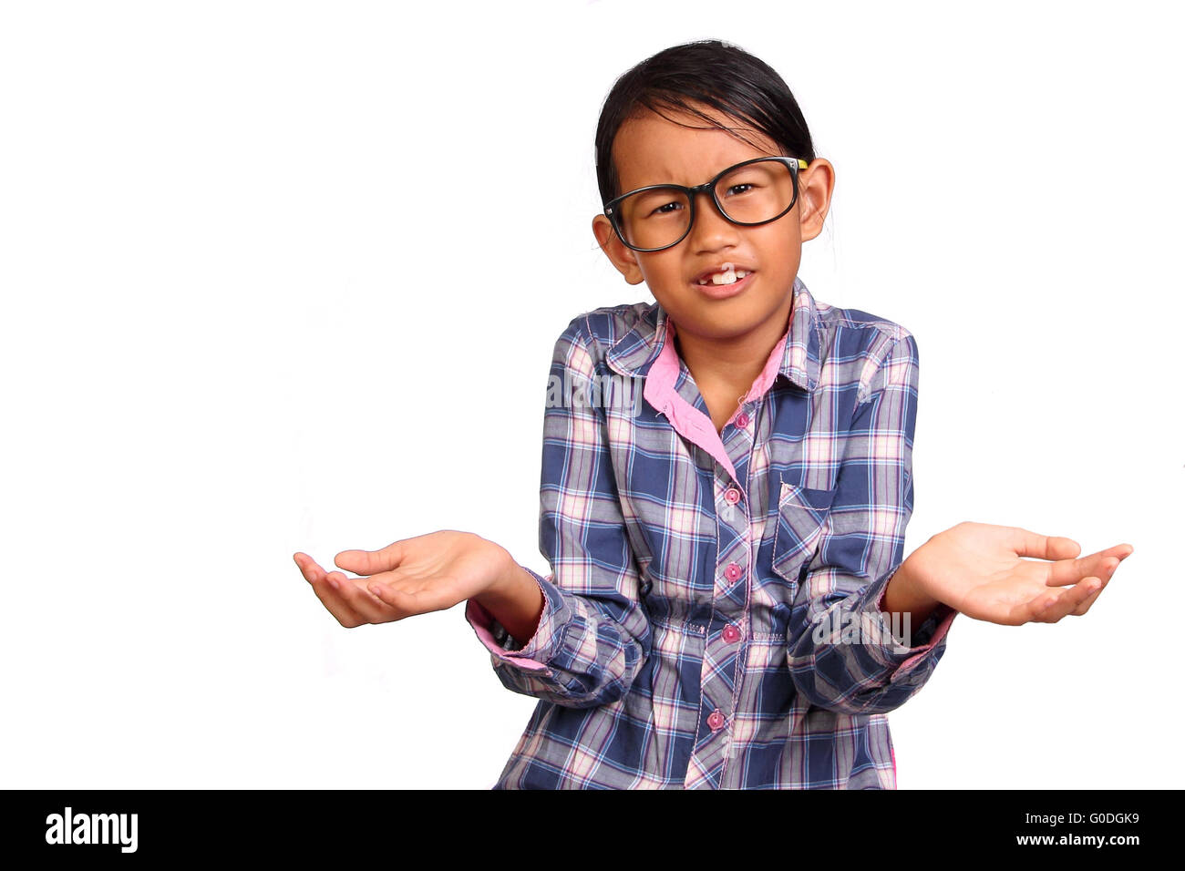Little girl with glasses performing shrug or I don't know gesture isolated on white Stock Photo