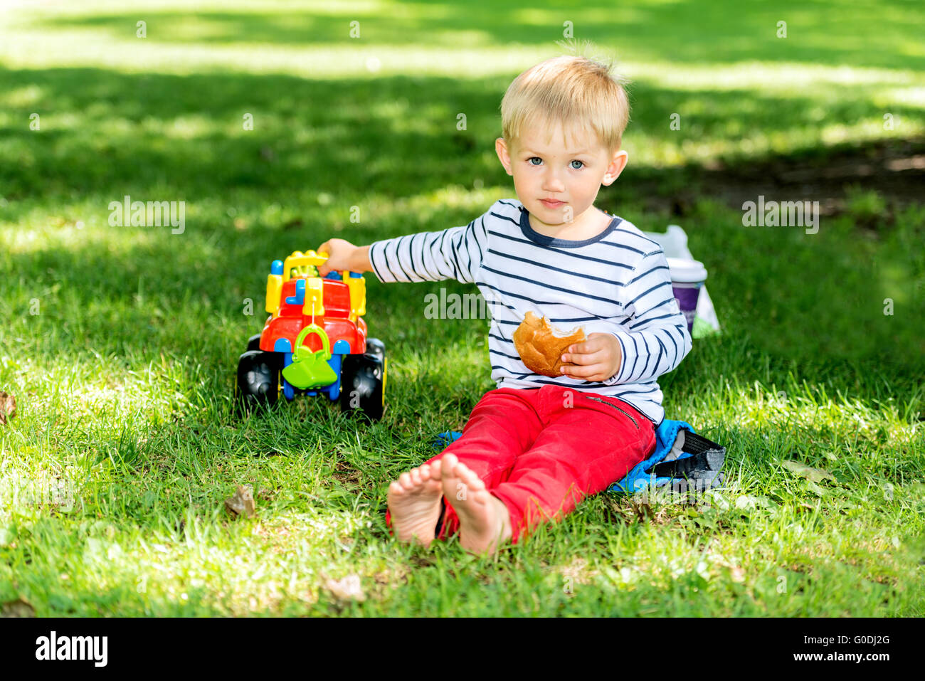 Little preschool boy playing with big toy car Stock Photo Alamy