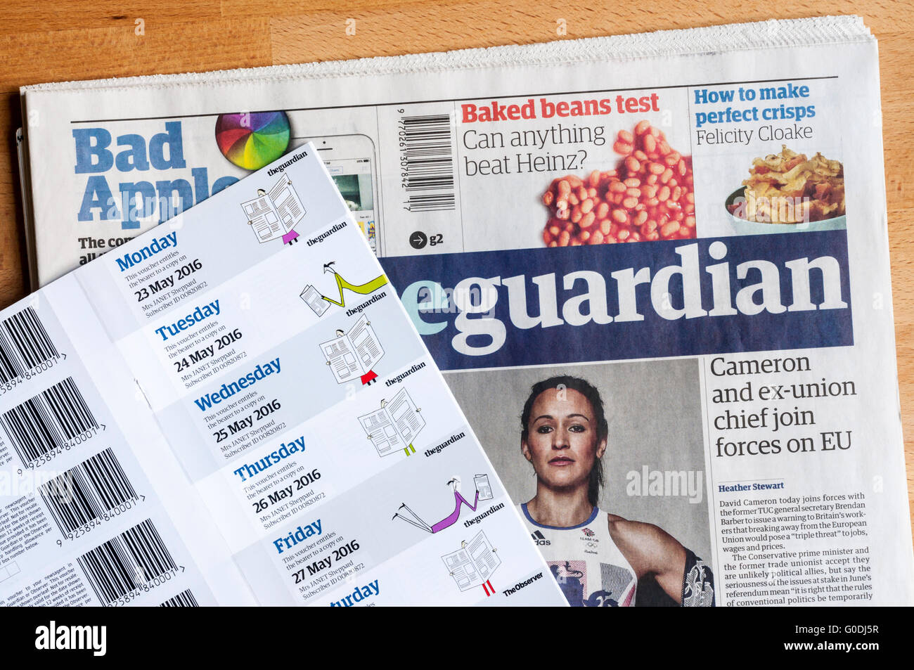 A copy of The Guardian newspaper with a book of subscription vouchers or coupons issued to subscribers. Data has been anonymised Stock Photo