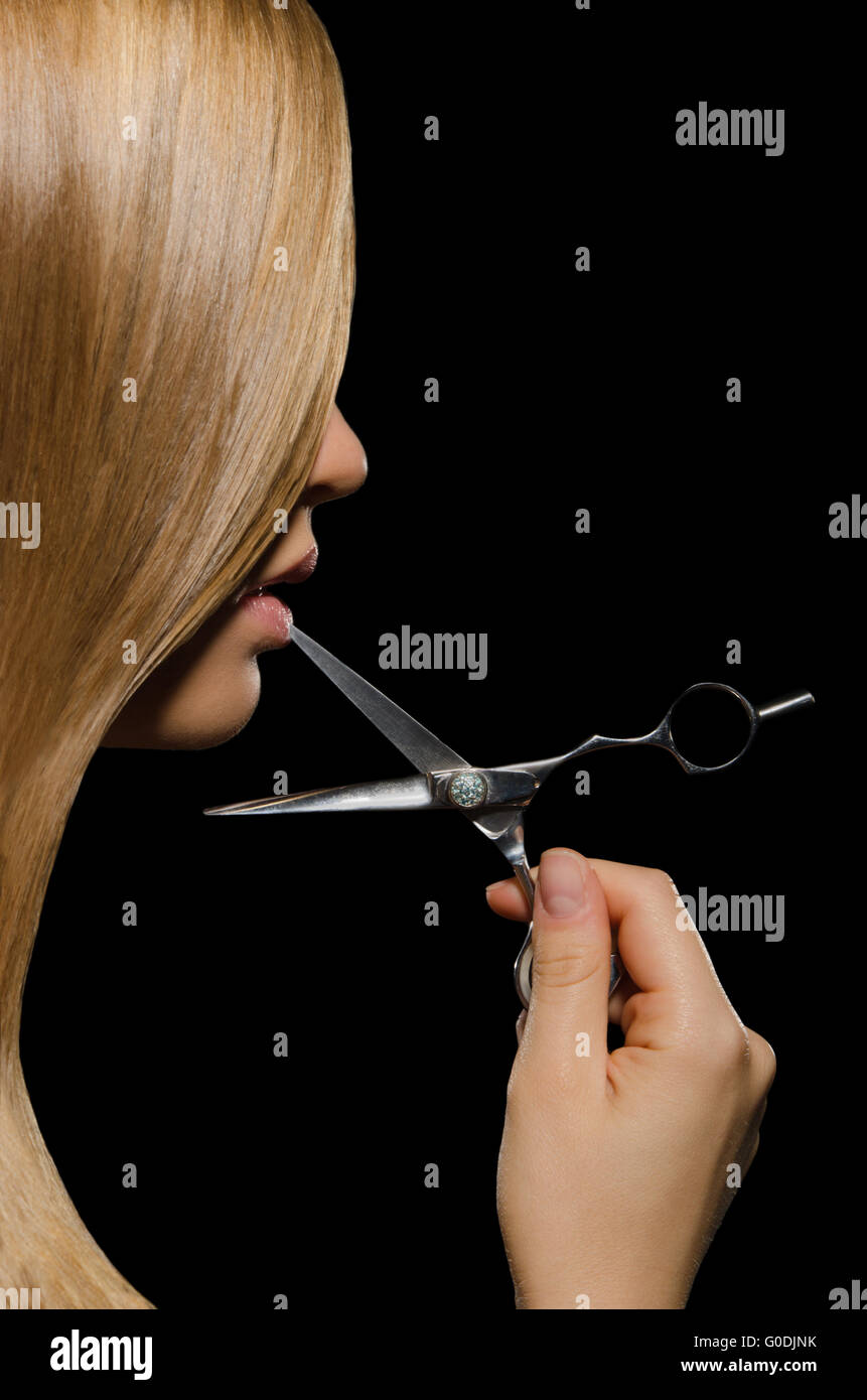 young woman with straight hair and scissors mouth Stock Photo Alamy