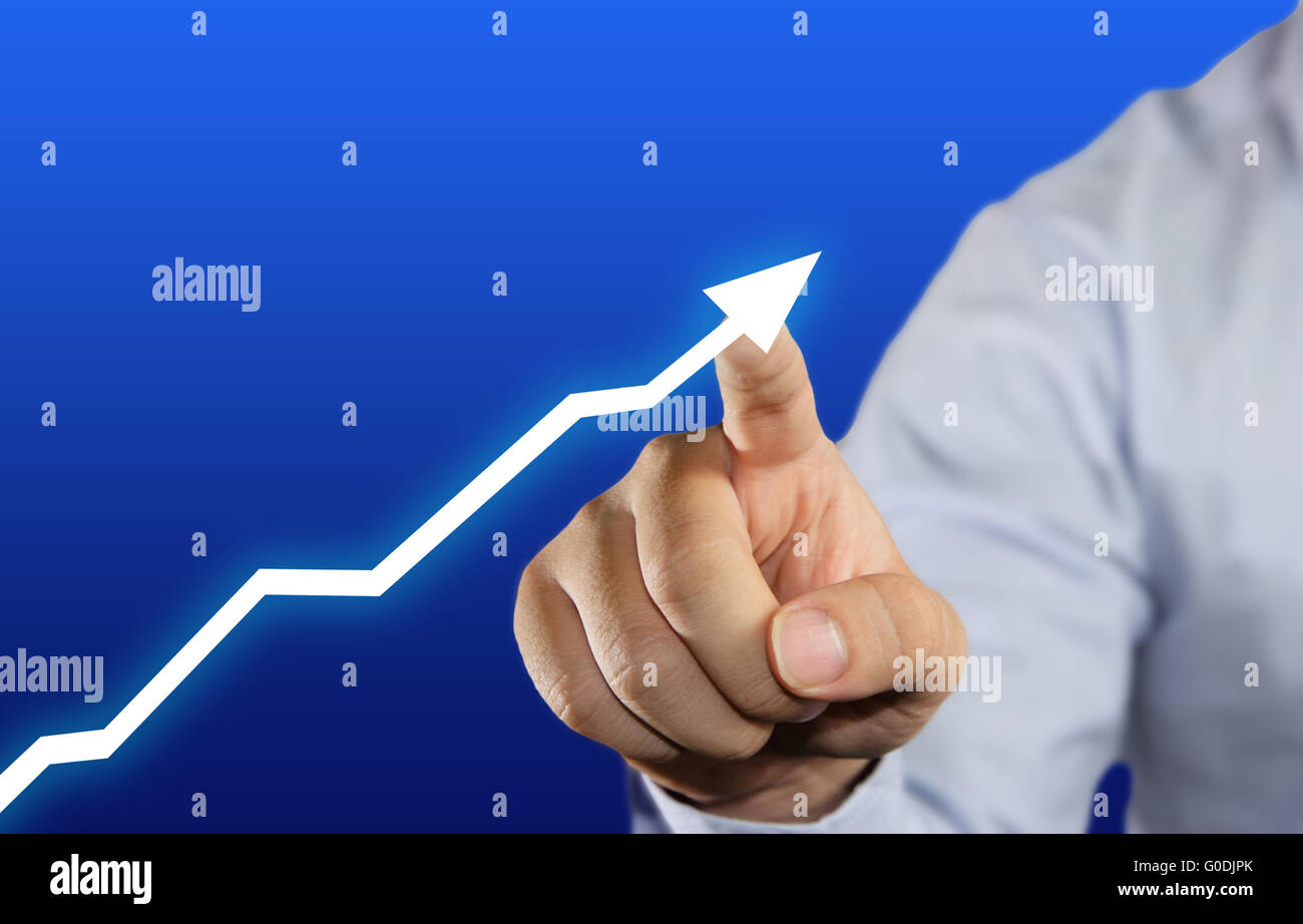 Hand of a businessman touching up arrow graphic on virtual screen over blue background Stock Photo
