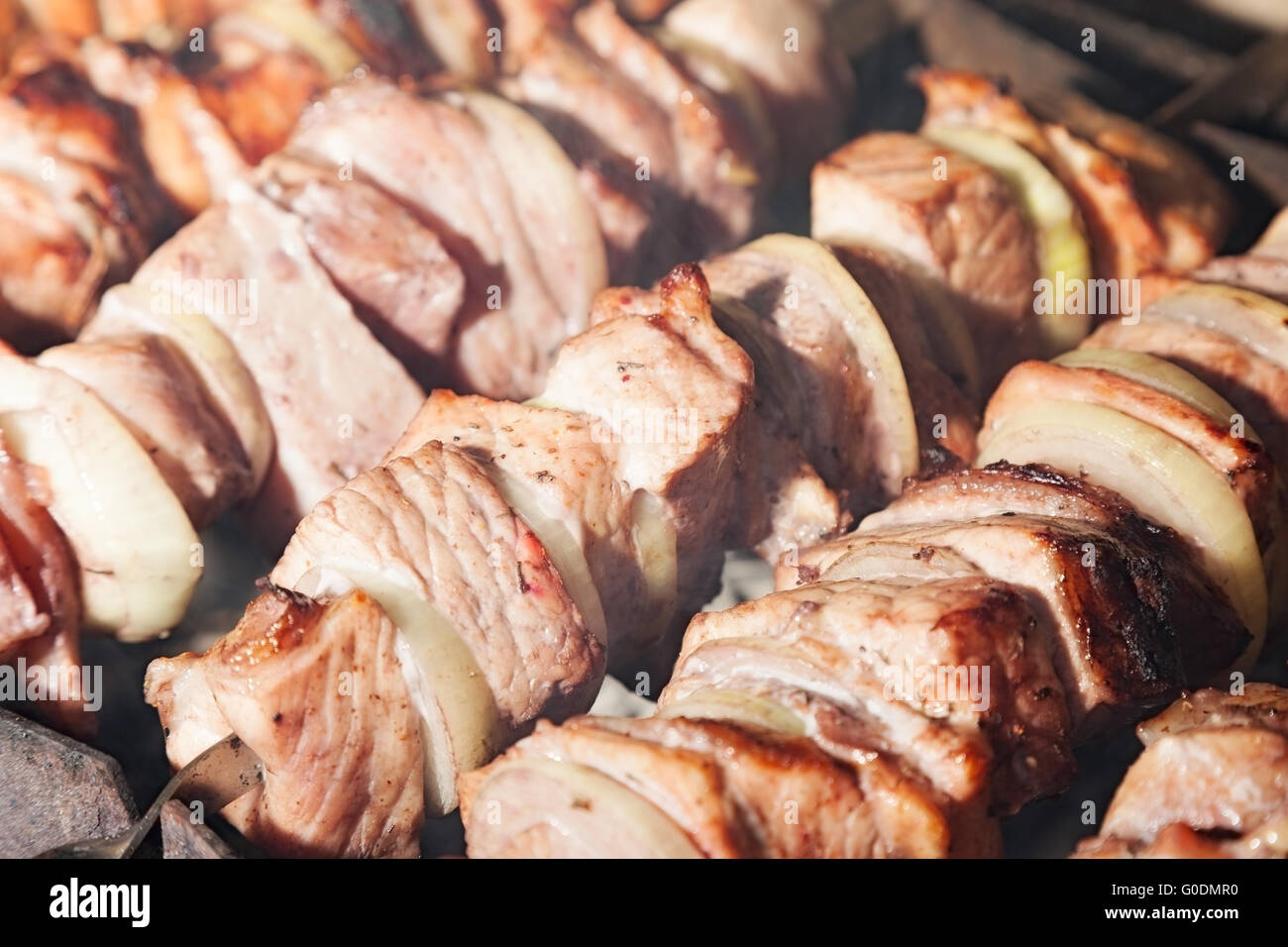 shashlik with onions. Juicy slices of meat being prepared in the heat. Delicious juicy meal Stock Photo